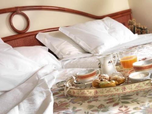 En eller flere senge i et værelse på Hotel Italia