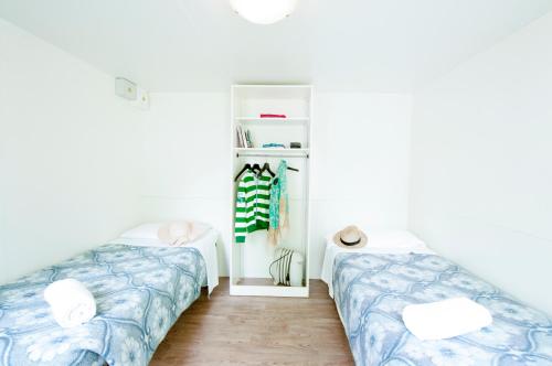 a bedroom with two beds and a closet at Camping Serenissima in Malcontenta