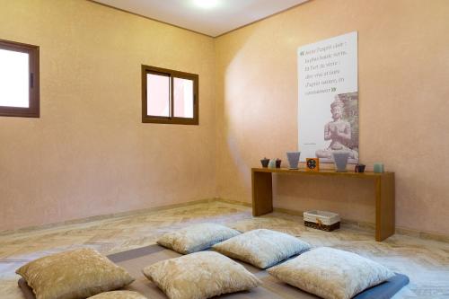 a room with four pillows on the floor with a poster at Domaine Rosaroum in Marrakech