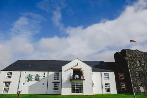 a white building with a window with statues on it at Bushmills Inn Hotel & Restaurant in Bushmills