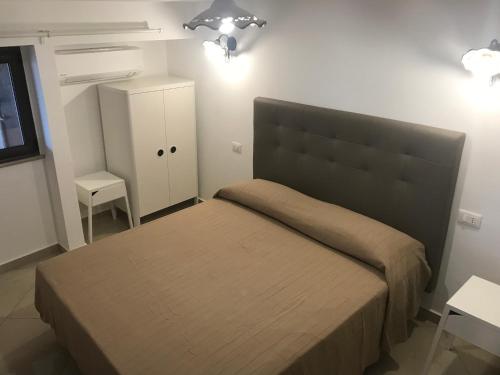a bedroom with a large bed and a white cabinet at B&B Villa sul Mare in Melito di Porto Salvo
