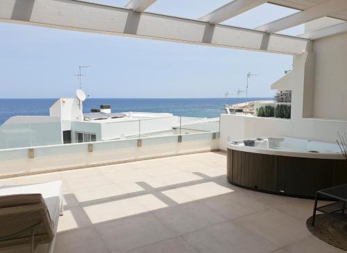 a balcony with a tub and a view of the ocean at Fiume Luxury Apartments near the SEA in Monopoli