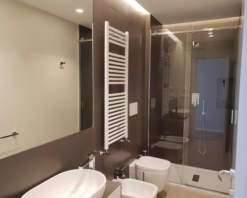 a bathroom with a toilet and a sink and a shower at Fiume Luxury Apartments near the SEA in Monopoli