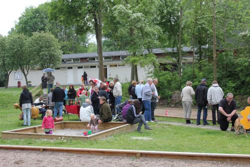a group of people standing around in the grass at Nivå Camping & Cottages in Nivå