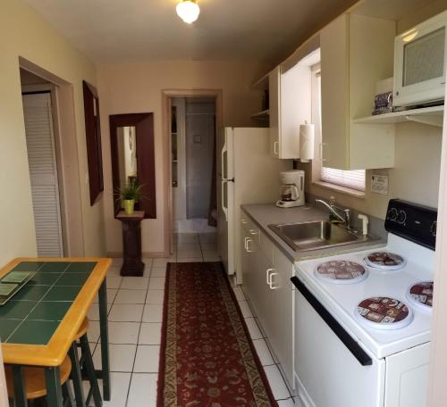 a kitchen with a sink and a counter top at INN LEATHER GUEST HOUSE-GAY MALE ONLY in Fort Lauderdale