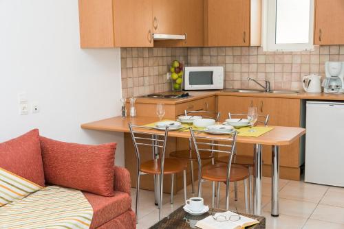 a kitchen with a table and chairs and a couch at Di Palai in Tsilivi
