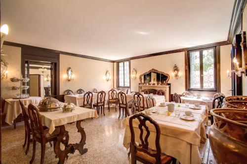 a large dining room with tables and chairs in it at Pensione Seguso in Venice