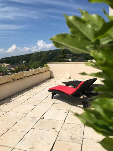 a red chair sitting on top of a patio at VillaSarda Drome in Sauzet