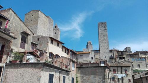 an old city with towers on top of buildings at Affittacamere Chiti Melania in San Gimignano