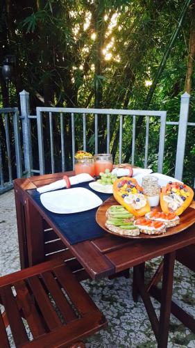 a wooden table with plates of food on it at Dos Aguas in Rio Grande