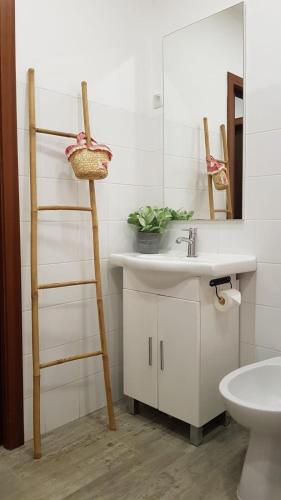 a bathroom with a sink and a ladder next to a mirror at Casa dos chocalhos-Piscina-Perto Praia Fluvial-Vista incrível e sossego in Mértola