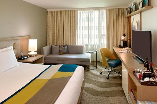 a hotel room with a bed and a desk at The Hotel Zags Portland in Portland