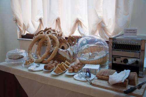 a table with a bunch of bread and baskets on it at Grand Hotel Paradiso in Catanzaro Lido