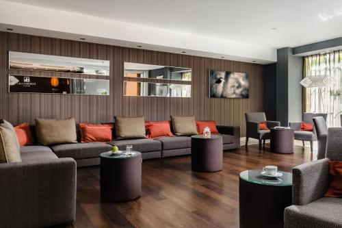a living room with couches and tables at Eurostars Asta Regia Jerez in Jerez de la Frontera