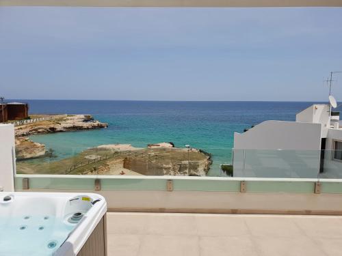 a bathroom with a tub and a view of the ocean at Fiume Luxury Apartments near the SEA in Monopoli