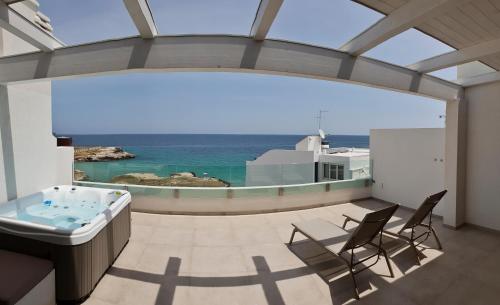 a bathroom with a tub and a view of the ocean at Fiume Luxury Apartments near the SEA in Monopoli