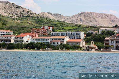 a town on the shore of a body of water at Apartmani Matija in Metajna