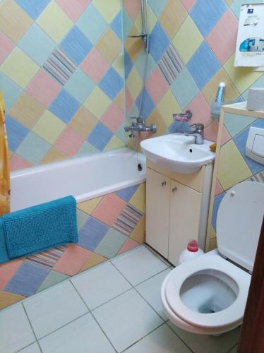 a bathroom with a toilet and a sink at Apartment on Voli Avenue 21 in Lutsk