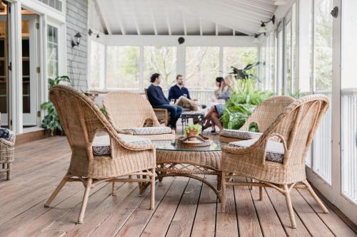a patio with wicker chairs and a table on a porch at Cape Arundel Inn and Resort in Kennebunkport