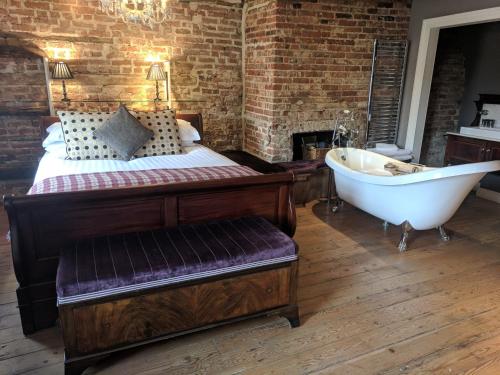 a bedroom with a bed and a bath tub at The Wellington in Welwyn