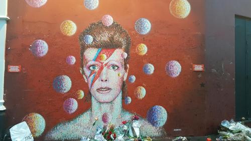 a painting of a woman on the side of a wall at Artistic Pied-à-Terre, Steps from the Tube, Moments from London's Heart in London