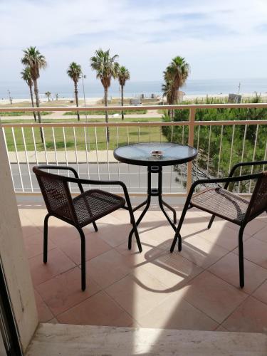 a table and two chairs on a balcony with the beach at B&B Altamarea in Marina di Schiavonea
