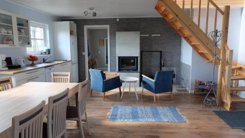 a kitchen and dining room with a table and blue chairs at Tahula Puhkemaja in Tahula