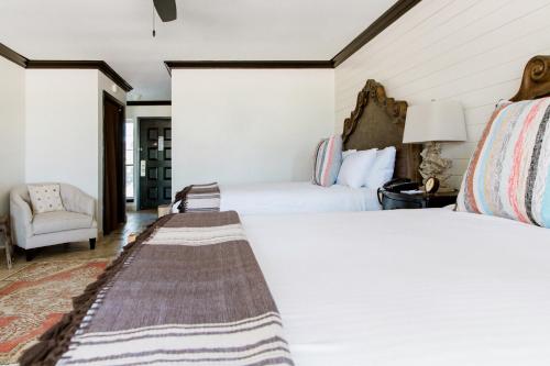 a hotel room with two beds and a chair at Hillside Boutique Hotel in Castroville