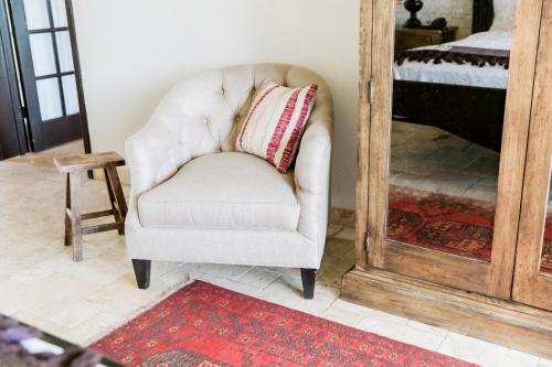 a chair with a pillow in a room with a mirror at Hillside Boutique Hotel in Castroville