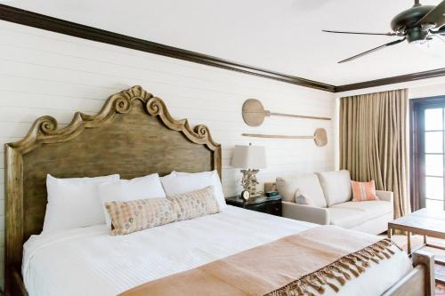 a bedroom with a large bed and a couch at Hillside Boutique Hotel in Castroville