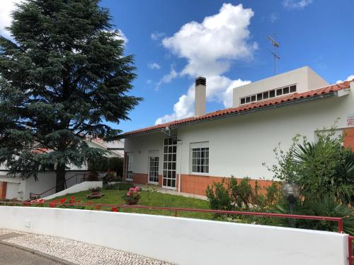 a white house with a white fence at Quinta Nova do Almeida in Alcobaça