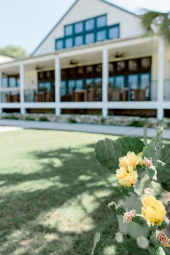 a building with yellow flowers in front of it at Hillside Boutique Hotel in Castroville