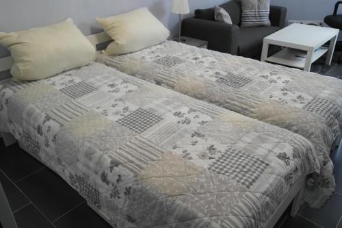 a bed with a quilt on it in a room at Jägerhof Apartments in Wiesbaden