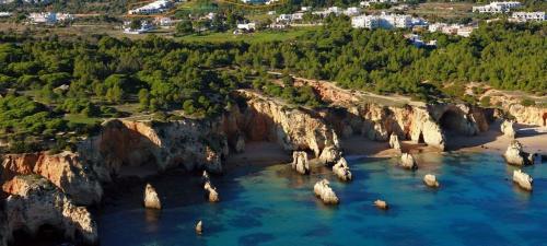 an aerial view of a beach with rocks in the water at Ria Sunset House Alvor in Alvor
