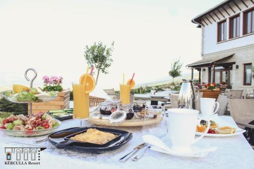 a table with plates of food on top of a table at KERCULLA Resort in Gjirokastër