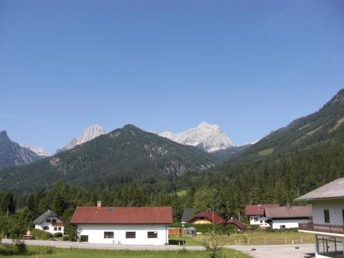 a village with mountains in the background at Hotel garni Landhaus Bürtlmair in Hinterstoder