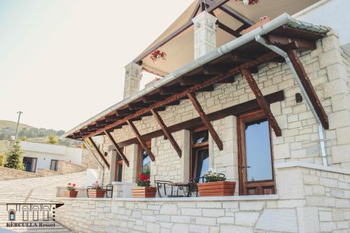 a building with windows and plants on it at KERCULLA Resort in Gjirokastër