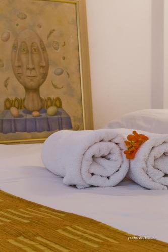 a couple of towels sitting on a bed at Potideon Villa in Karpathos