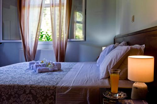 a bedroom with a large bed with a window at Achilles Country House in Corfu Town