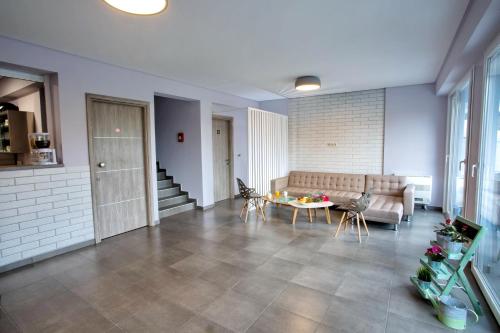a living room with a couch and a table at Isalos Suites in Néa Péramos