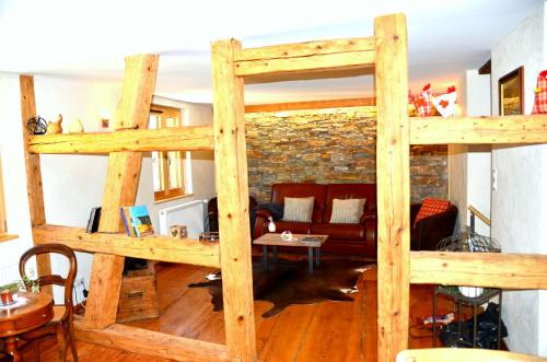 a loft bed in a living room with a couch at La Parenthèse in Kaysersberg
