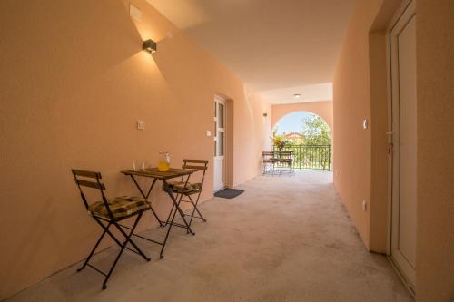 a hallway with a table and chairs and a balcony at Apartments Raspolic in Kastav