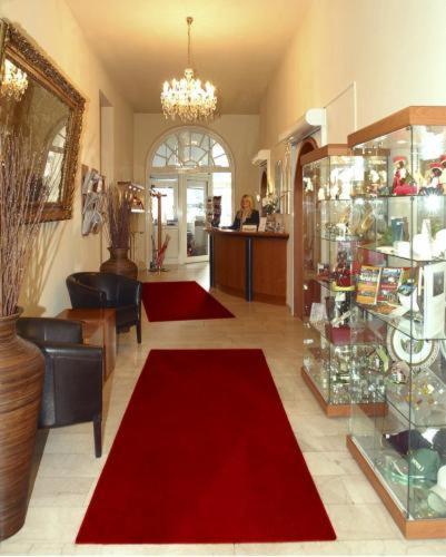 a room with red carpets on the floor in a store at Hotel Schweizer Hof - Superior in Baden-Baden