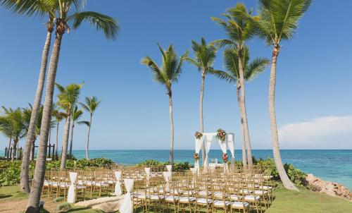 a wedding ceremony on the beach with palm trees at Sanctuary Cap Cana, a Luxury Collection Resort, Dominican Republic, Adult All-Inclusive in Punta Cana