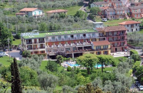 a hotel on a hill with a resort at Park Hotel Val Di Monte ***S in Malcesine