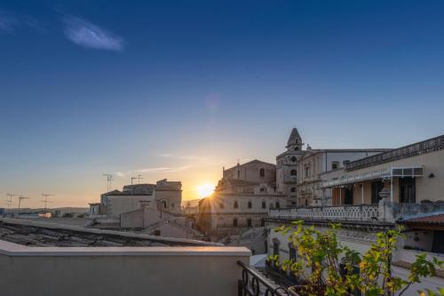 a view of the sunset from the roof of a building at Hotel Porta Reale in Noto