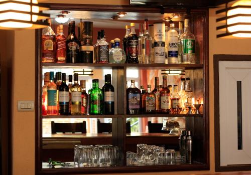 a bar filled with lots of bottles of alcohol at El Delfin Hotel y Restaurante in San Pedro La Laguna