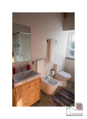 a bathroom with a sink and a toilet at Casa do Zé II AL in Velas
