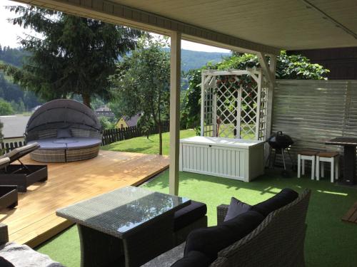 a patio with a table and a gazebo at Kwaterka in Brenna