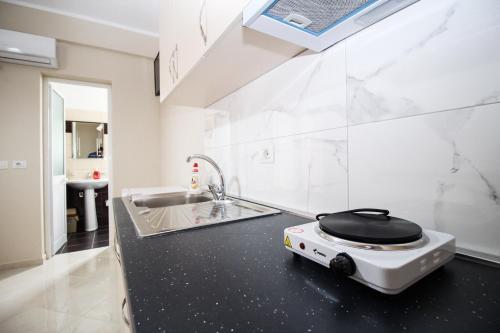 a kitchen with a black counter top with a toaster on it at Vila Kleon in Ksamil